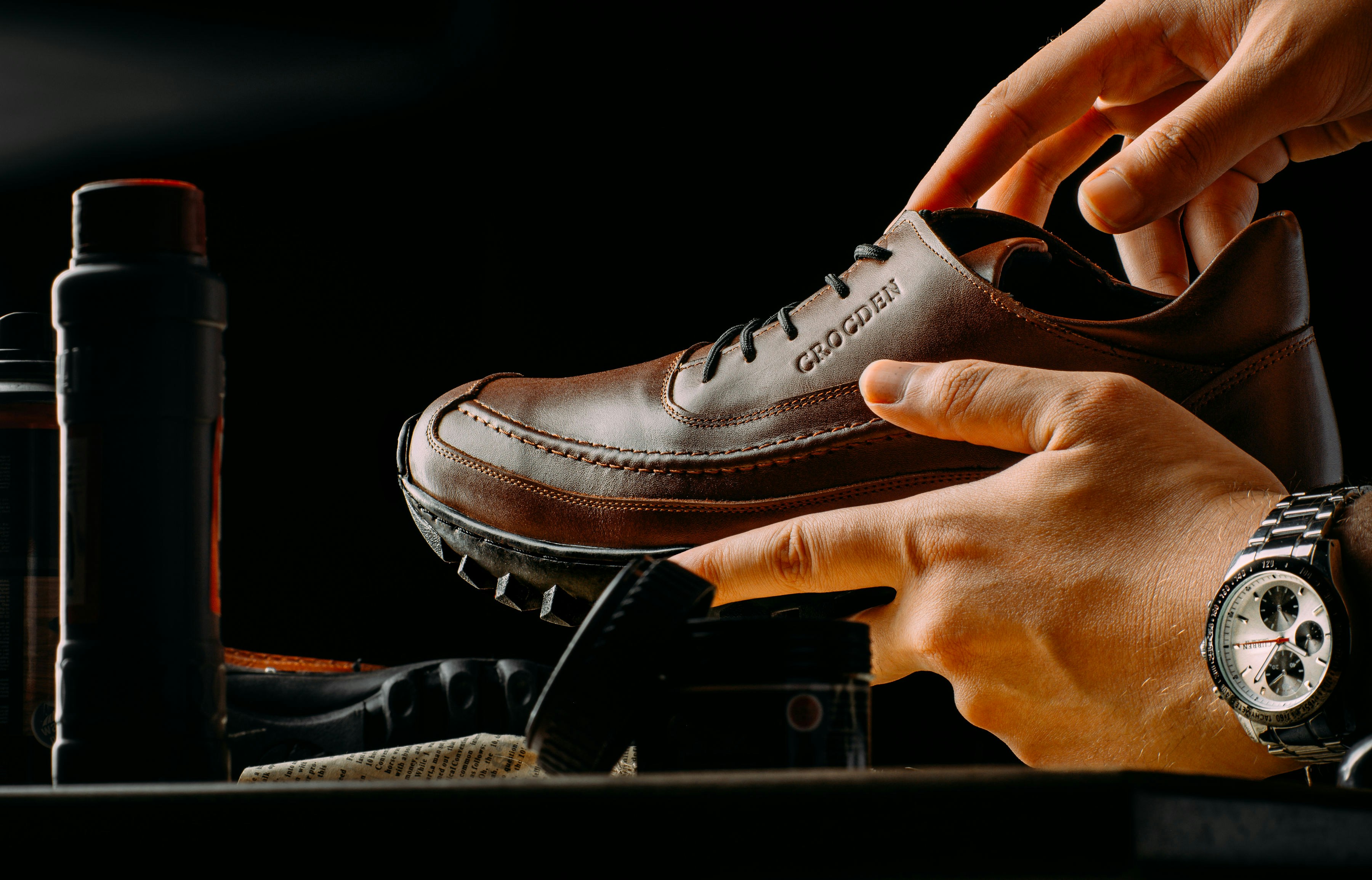 Craftsman holding a finished leather shoe